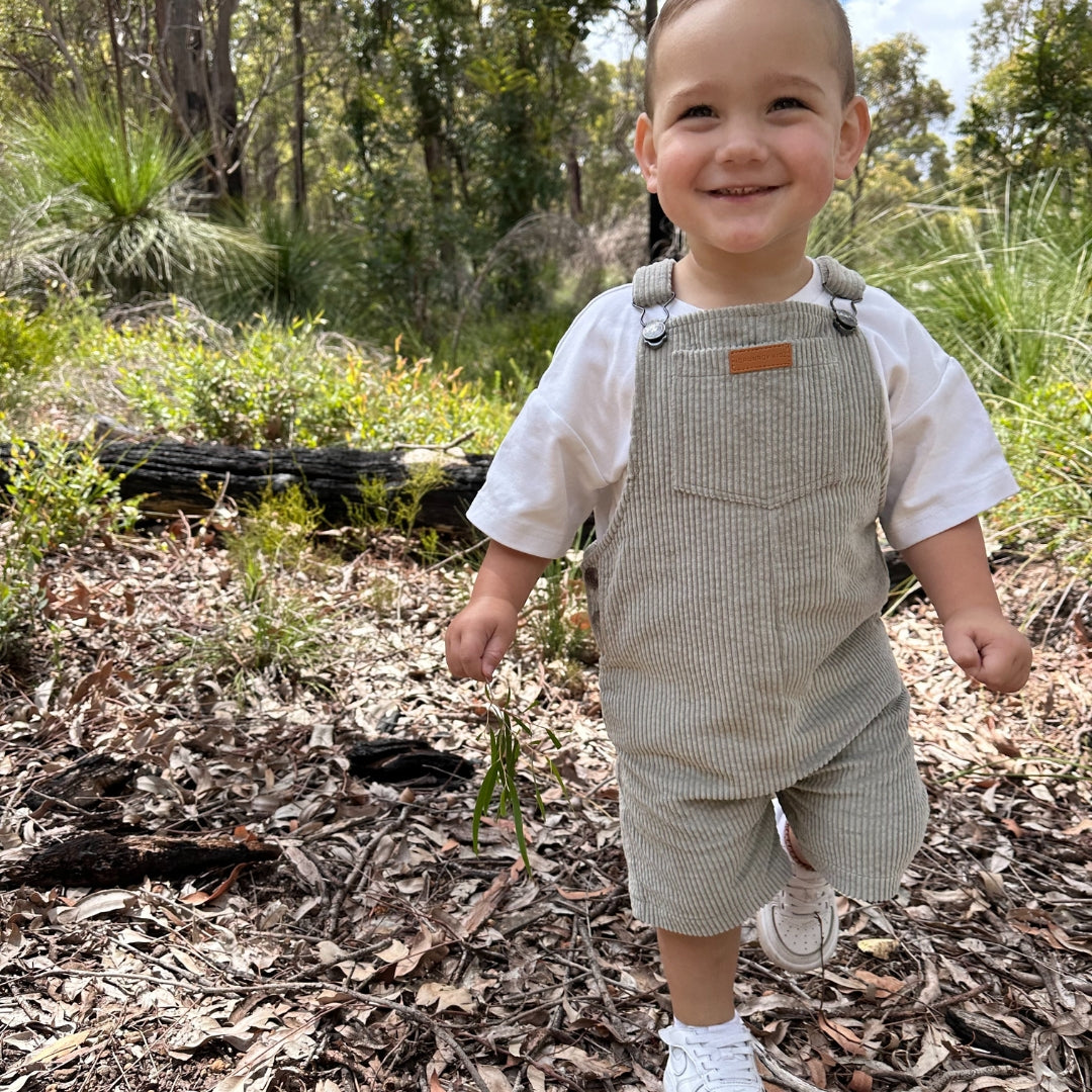 short leg overall, dungaree in colour sage made from organic cotton corduroy clothing for infants, toddlers and kids front view of overalls