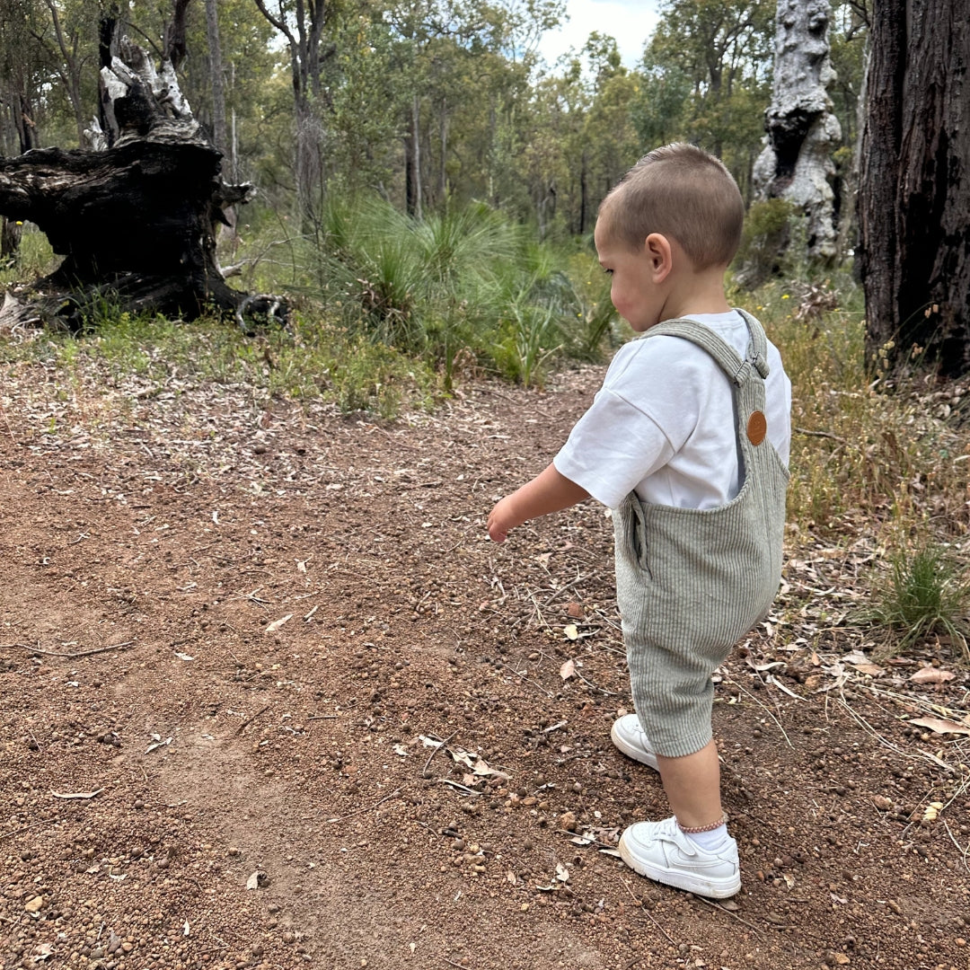 short leg overall, dungaree in colour sage made from organic cotton corduroy clothing for infants, toddlers and kids side view