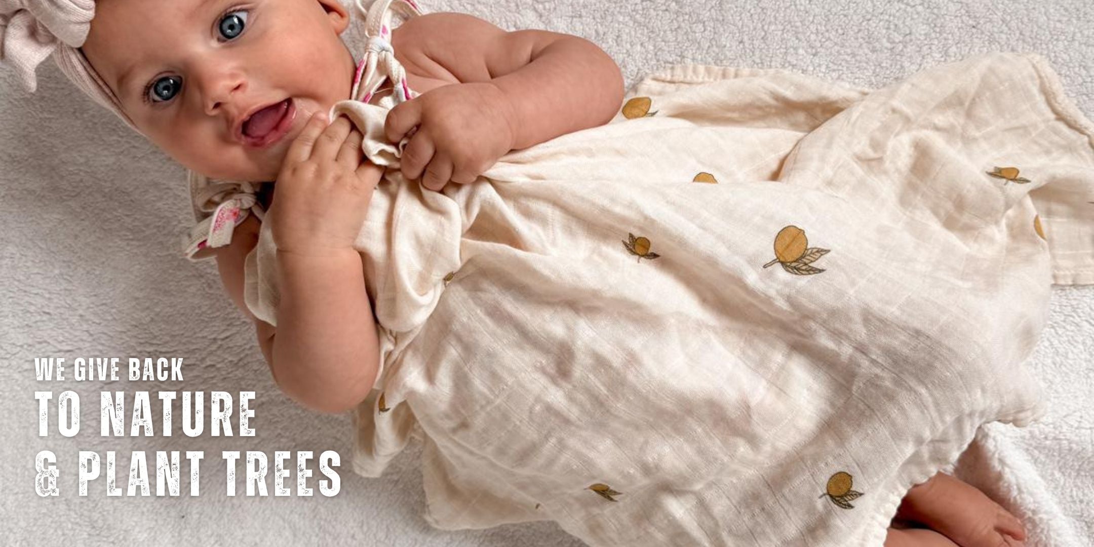 organic swaddle for newborns and babies in a beige and lemon style. organic cotton and bamboo